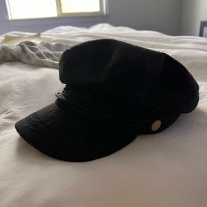 Black sailor hat with gold buttons .